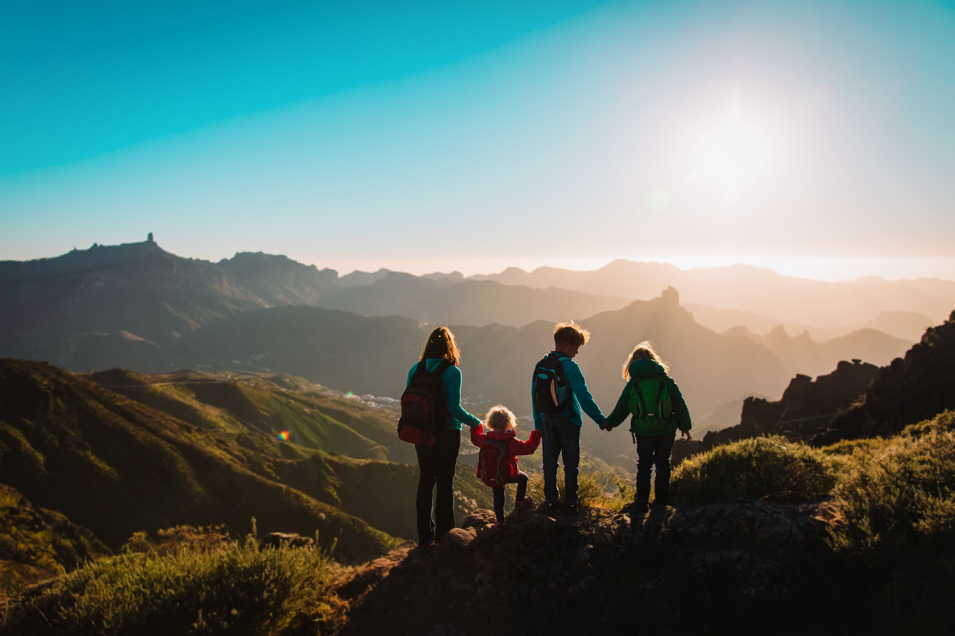 Mother with kids travel in mountains, family hiking